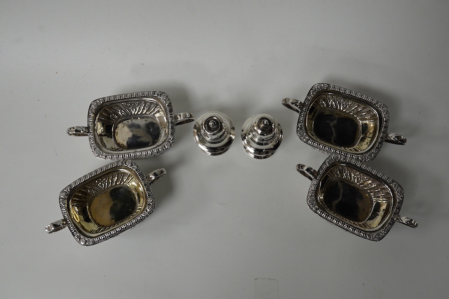 A set of four late Victorian embossed silver two handled salts, Birmingham, 1896, 98mm and a pair of silver peppers. Condition - fair to good